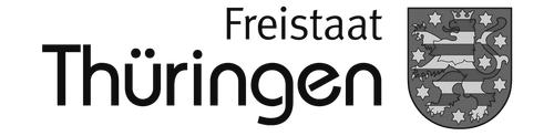 Wappen und Schriftzug in grau vom Freistaat Thüringen als Referenzkunde.